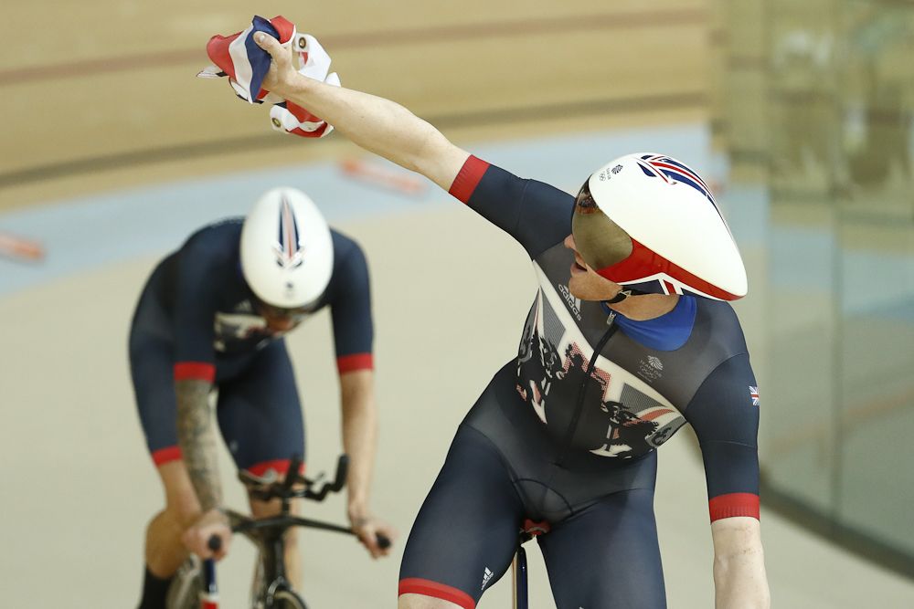 Britain's Edward Clancy (R) and Britain's Bradley Wiggins celebrate after winning gold in the men's Team Pursuit finals
