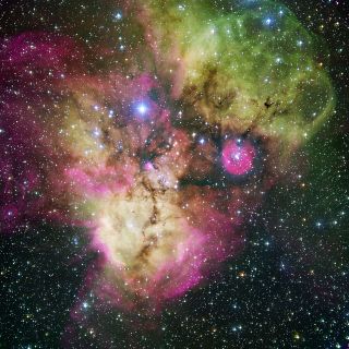This image from telescopes at the European Southern Observatory in Chile shows a vast stellar cluster surrounded by gas that resembles a vast cosmic ghost. The image, released on Dec. 25, 2005, hows the area surrounding the stellar cluster NGC 2467, locat