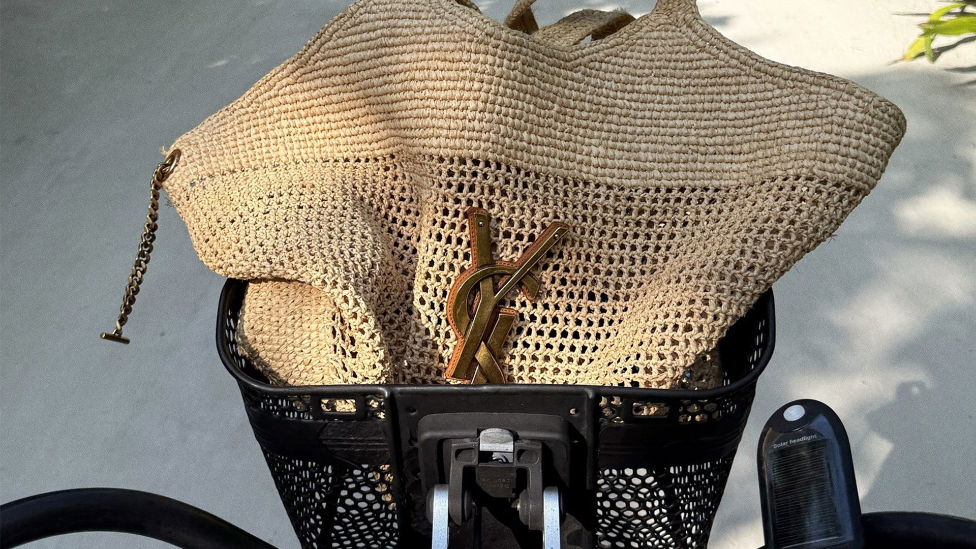 @hannahstraffordtaylor picture of bicycle basket with saint laurent raffia beach bag inside