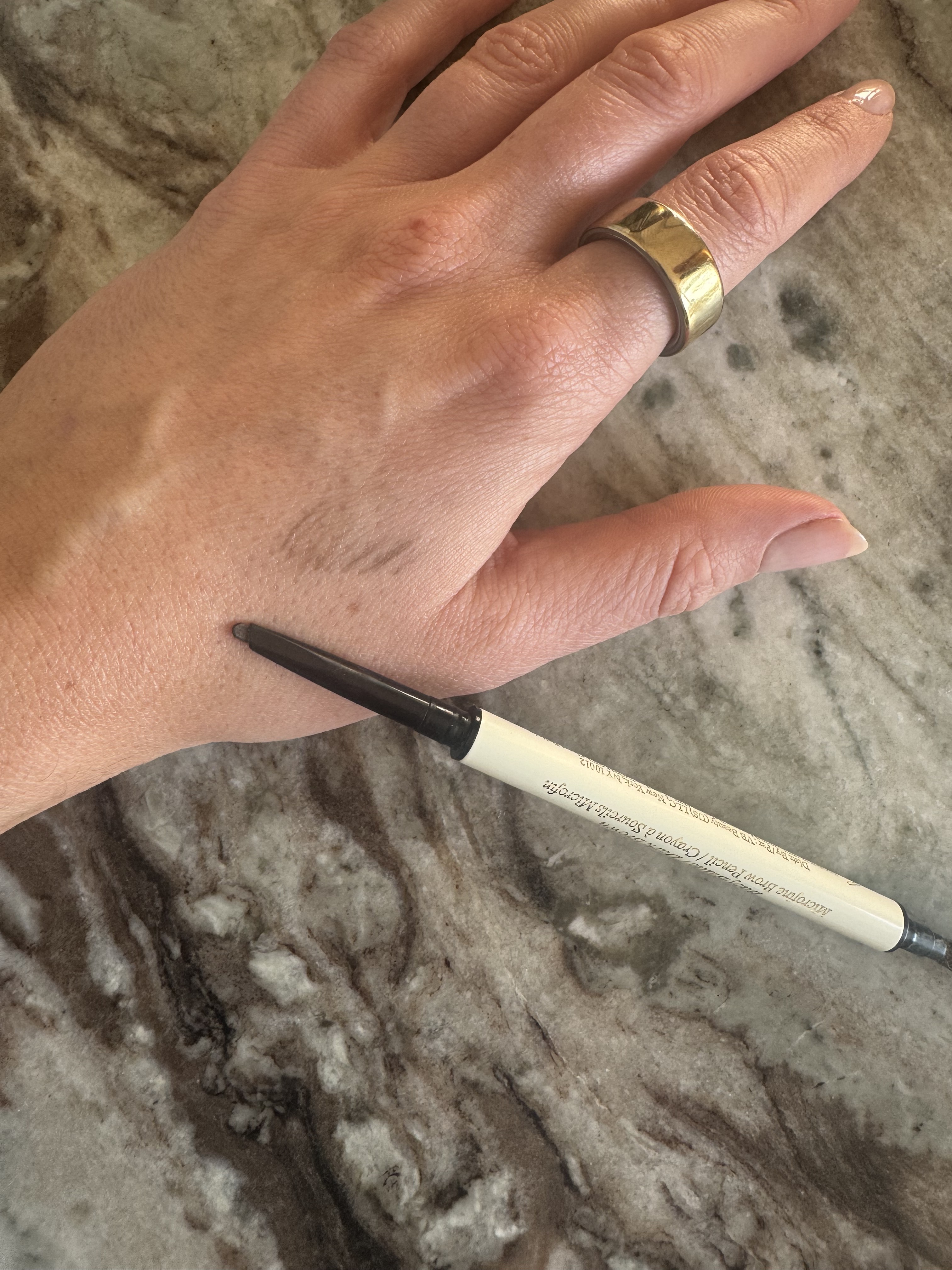 Beauty editor Eleanor swatching the Victoria Beckham Beauty brow pencil on her hand