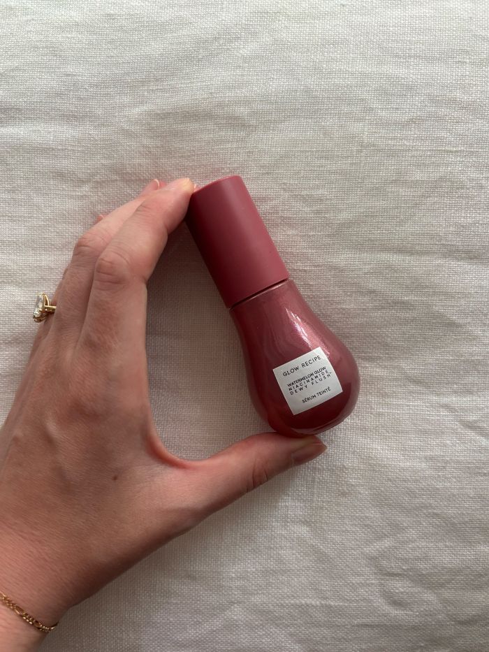 Deputy beauty editor Grace Lindsay holding the Glow Recipe Watermelon Glow Niacinamide Dewy Flush