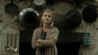 Fleur Delacour stands in the kitchen.