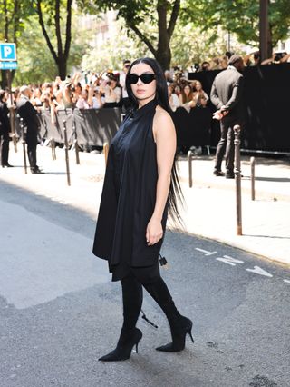 Charli XCX wearing a black skirt dress to couture week in Paris