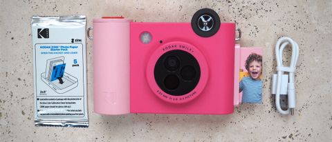 Kodak Smile+ camera in pink on a marbled surface