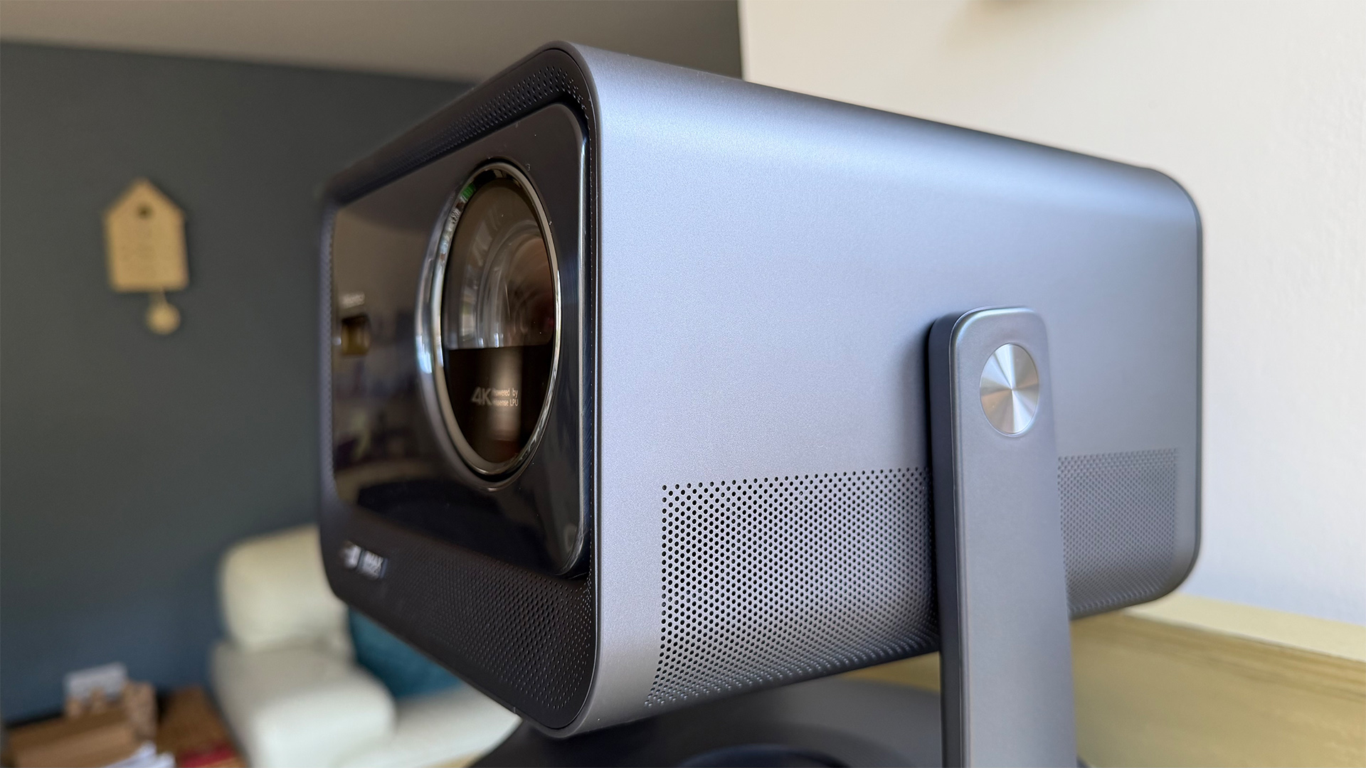 Hisense C2 Ultra home cinema projector in living room, side/front angle