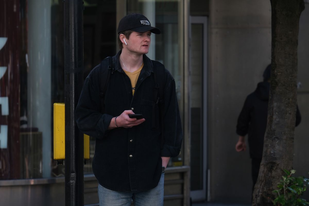 A man waiting at a pedestrian crossing