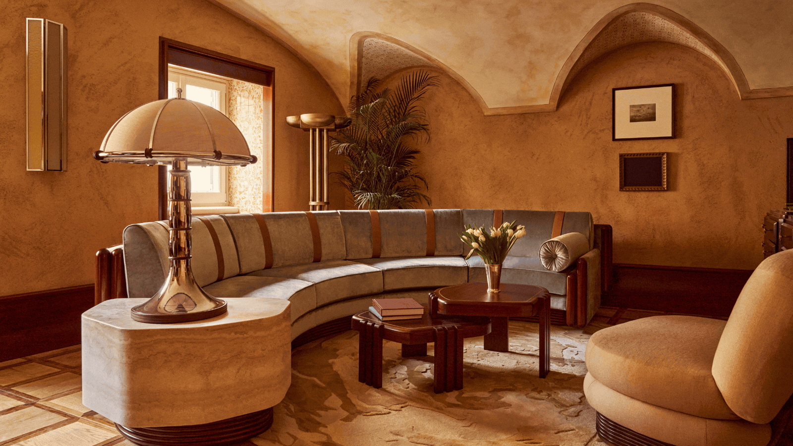 A rotating gif showcasing the terracotta, wood, and ochre-tinted, palatial interiors of a luxury hotels and its sun-soaked terrace.