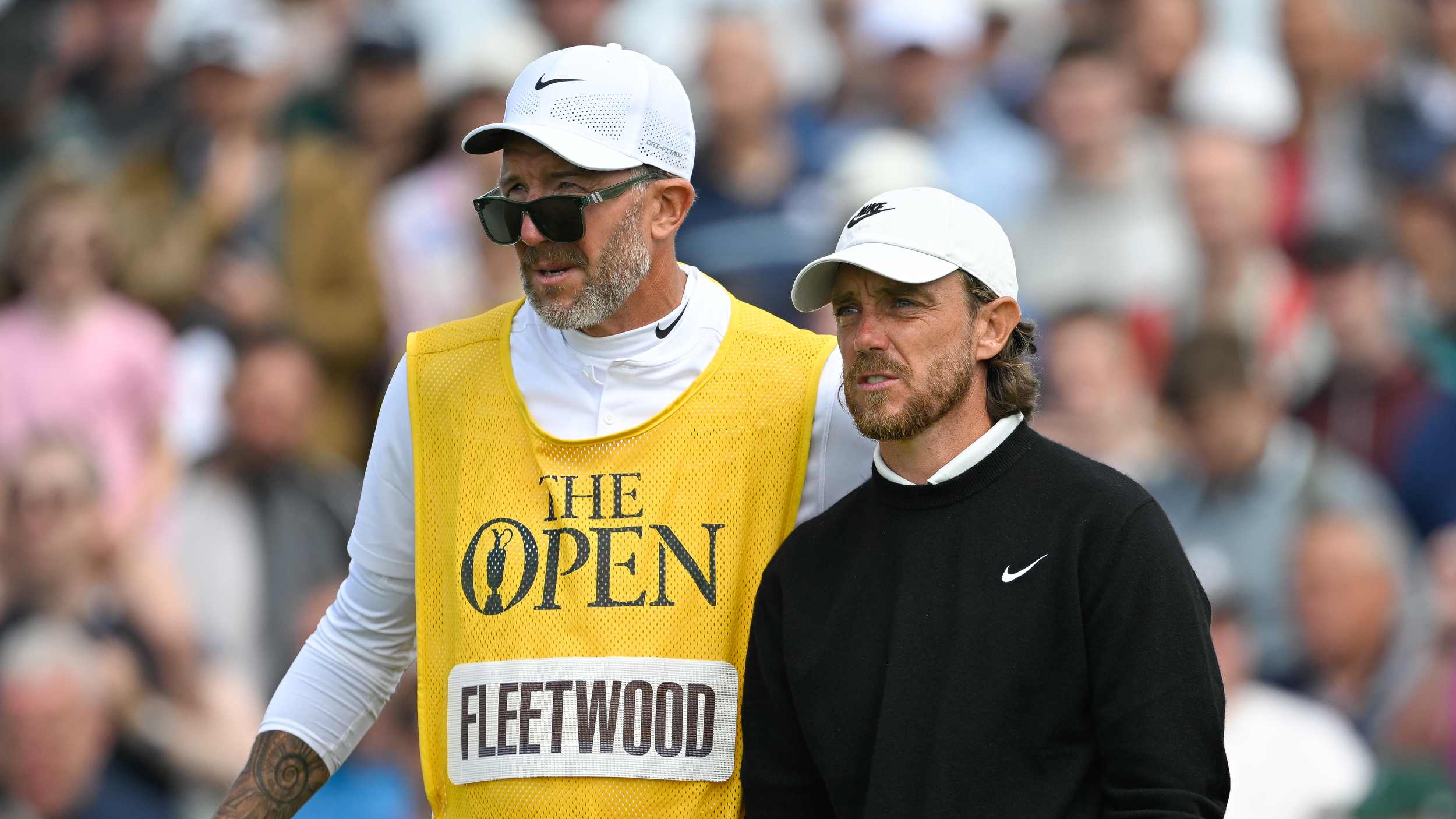 Tommy Fleetwood (right) and caddie, Ian Finnis look on during The Open Championship in 2025