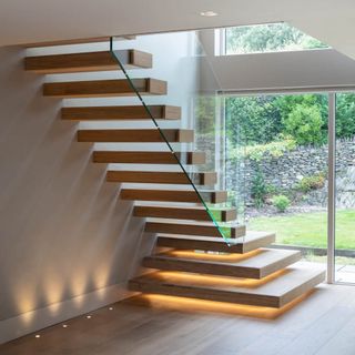 A modern staircase lit from beneath