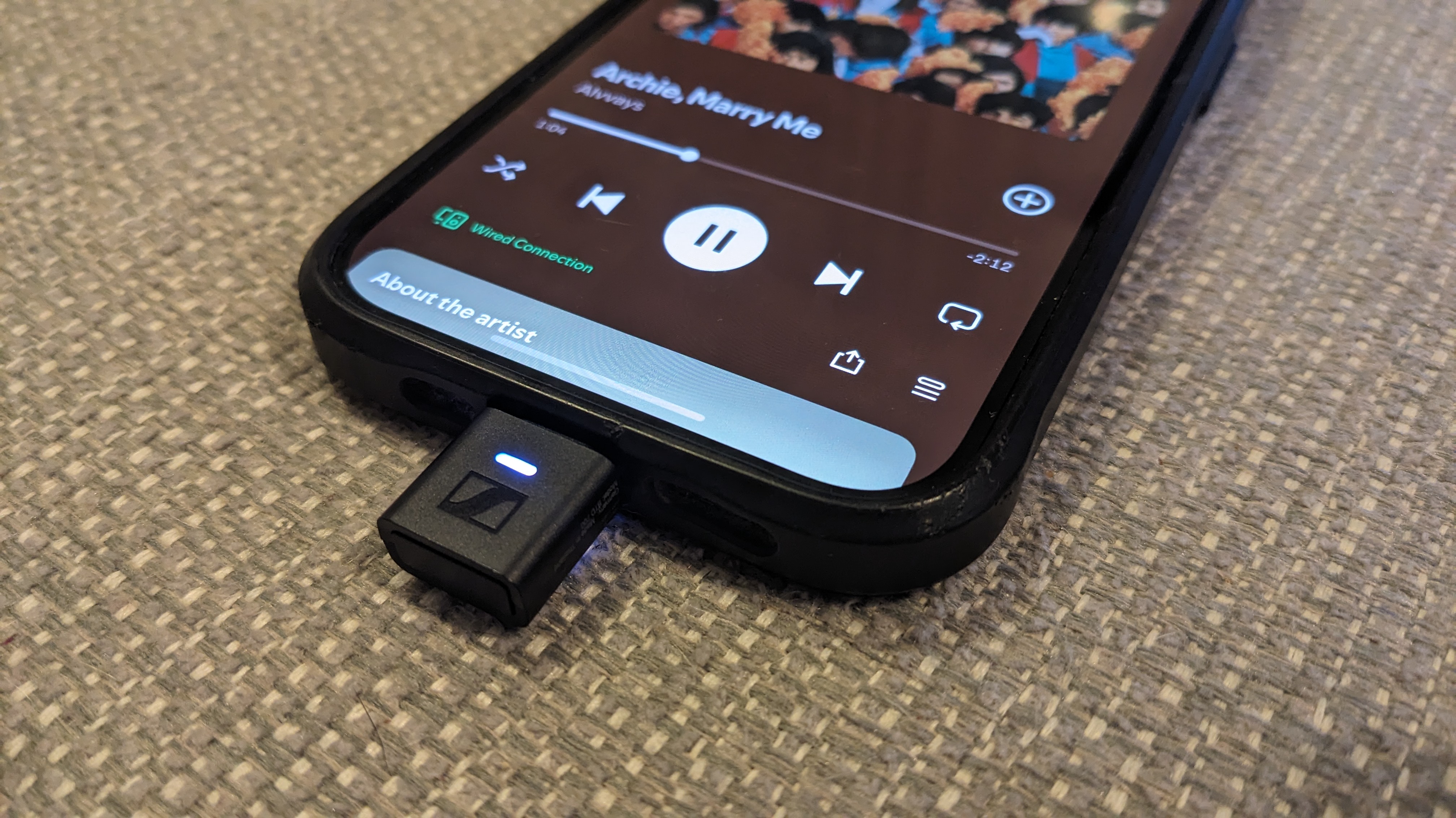 The bottom half of an iPhone with a small dongle connected