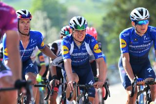 Iljo Keisse helps Remco Evenepoel to the finish, the young Belgian's left elbow was visibly swollen