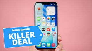 iPhone 17e held in hand against pink backdrop