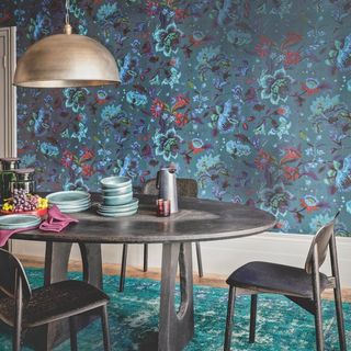 A navy blue pattern drenched kitchen with contrasting rug