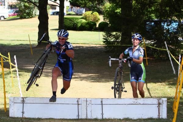 Laura Van Gilder throws her bike over the barrier.