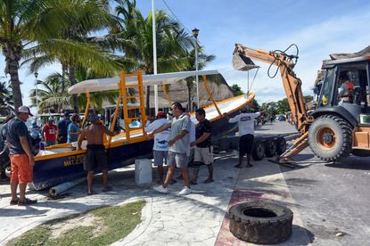 Residents of the Yucatan remove boats in preparation for Hurricane Delta.