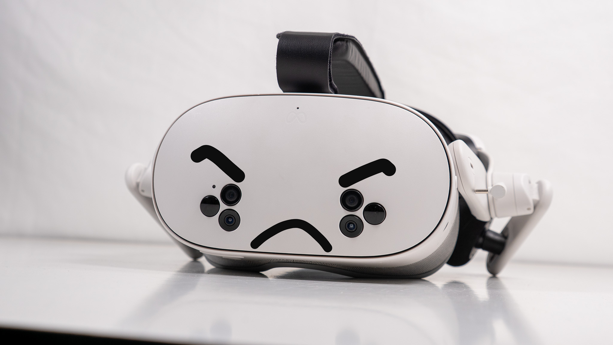 A Meta Quest 3S headset with an angry face drawn on it