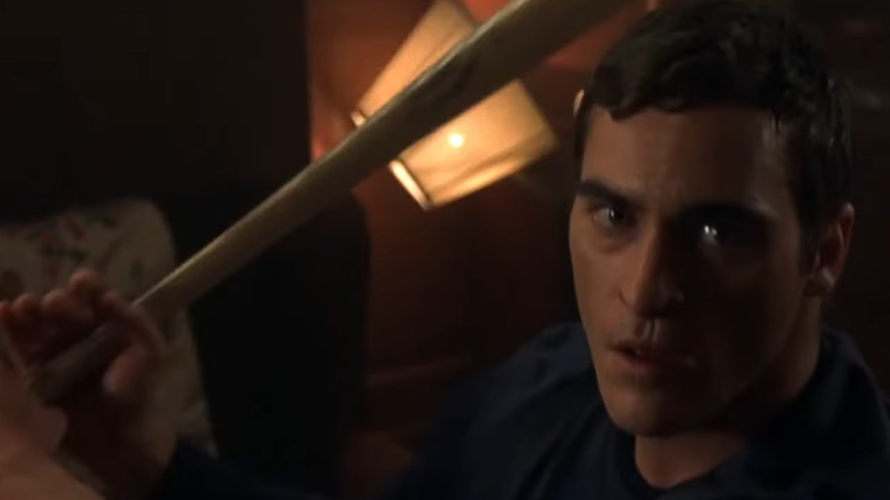 Joaquin Phoenix with a baseball bat in Signs