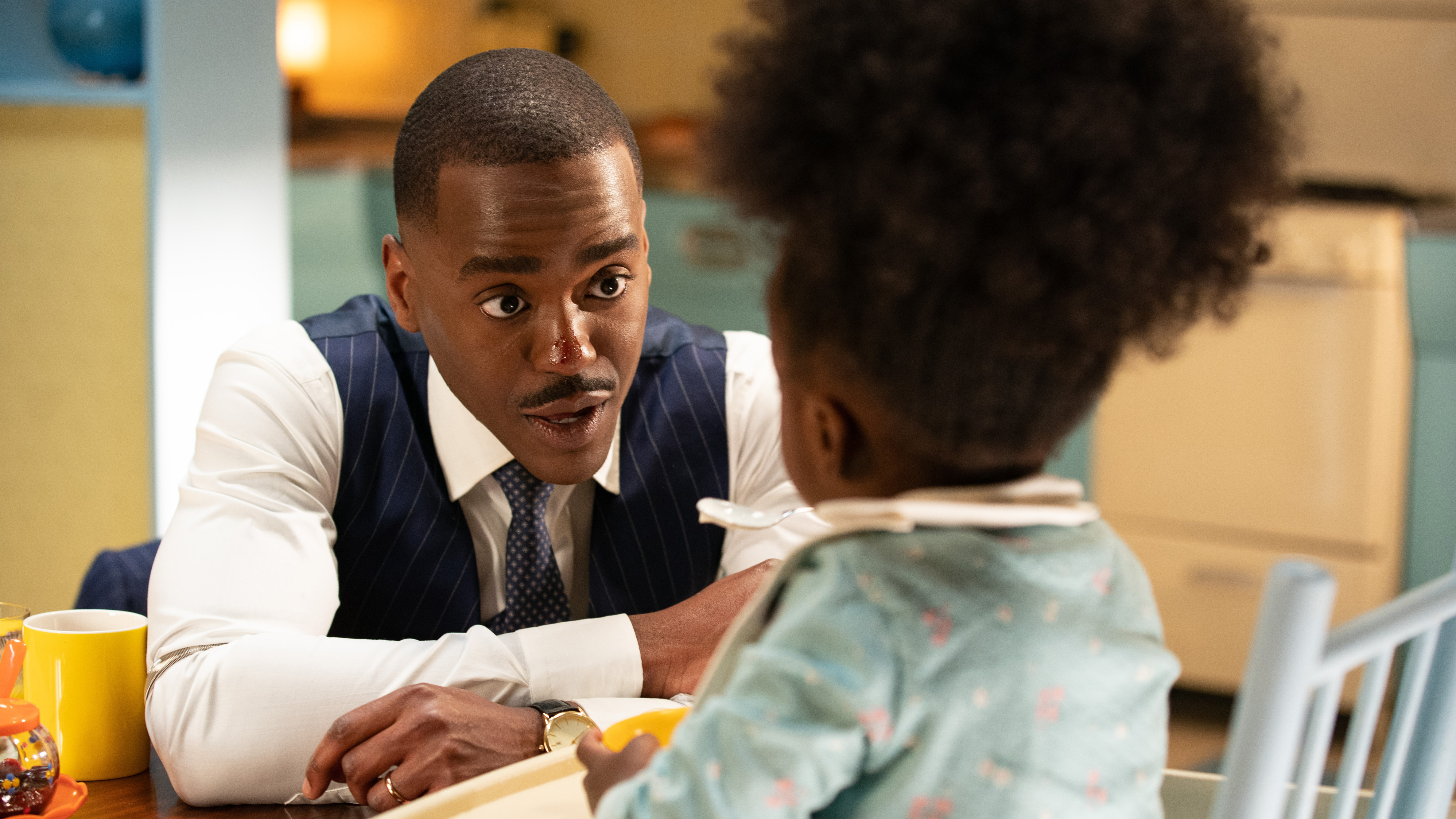 Ncuti Gatwa as the Doctor, talking to Poppy (Sienna-Robyn Mavanga-Phipps) in Doctor Who: 'Wish World'