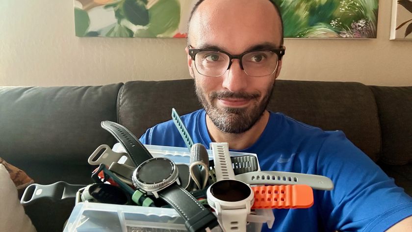 A selfie of the author holding a heaping organizational tray full of smartwatches.