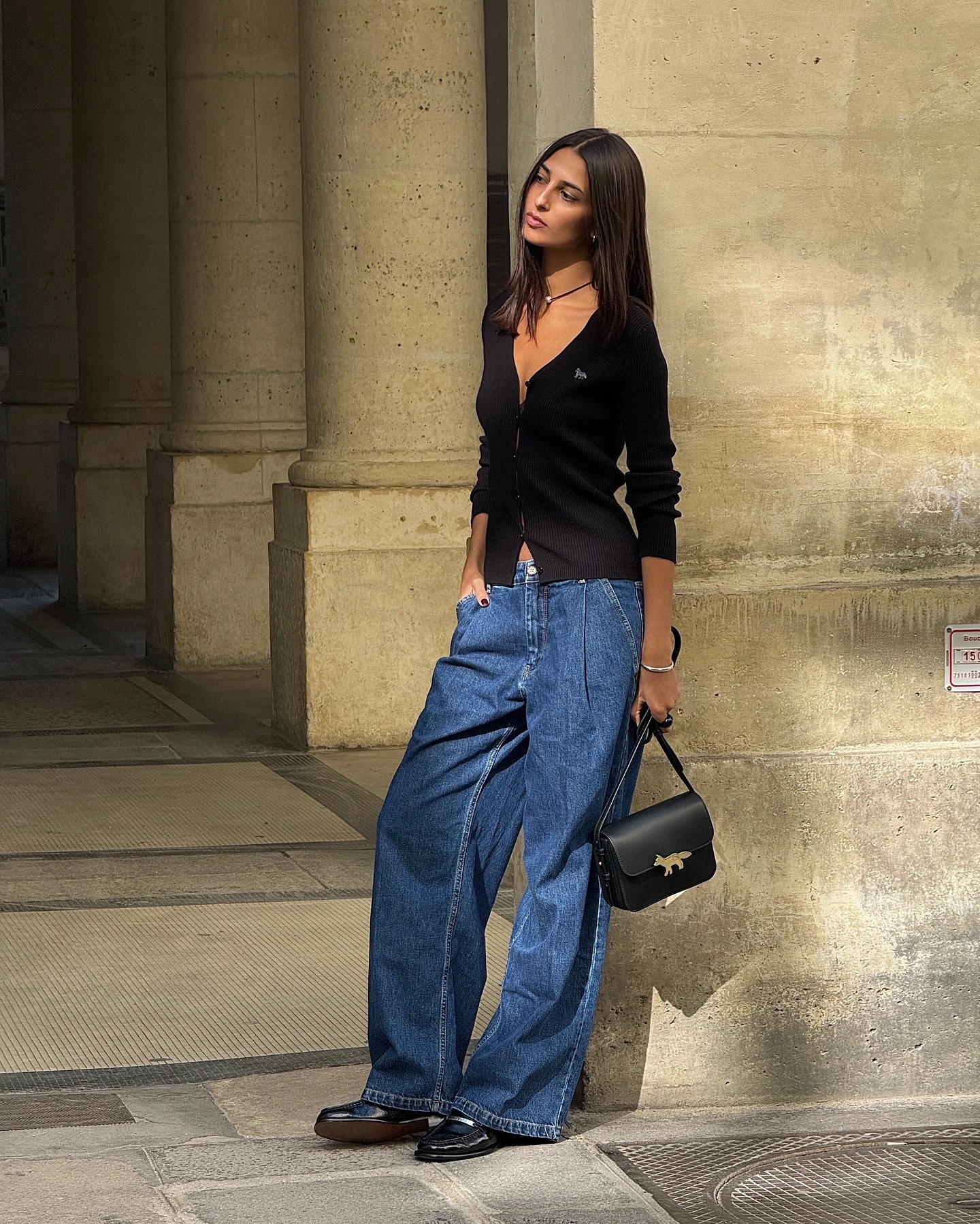 @salome.mory wearing jeans, a cardigan, and loafers