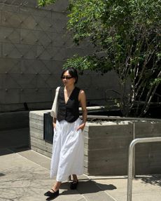 @dawn.tan wearing white skirt and black tailored vest