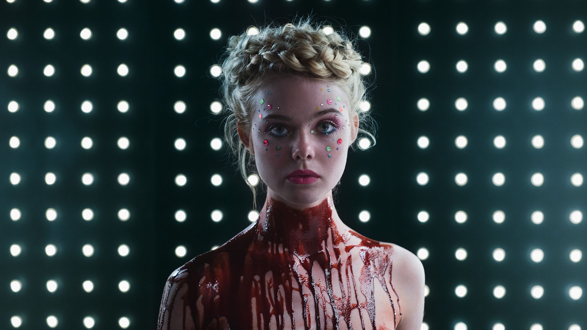 Elle Fanning as Jesse covered in blood during the horror movie, The Neon Demon.