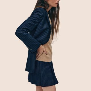 flat lay image of woman wearing navy pinstripe blazer