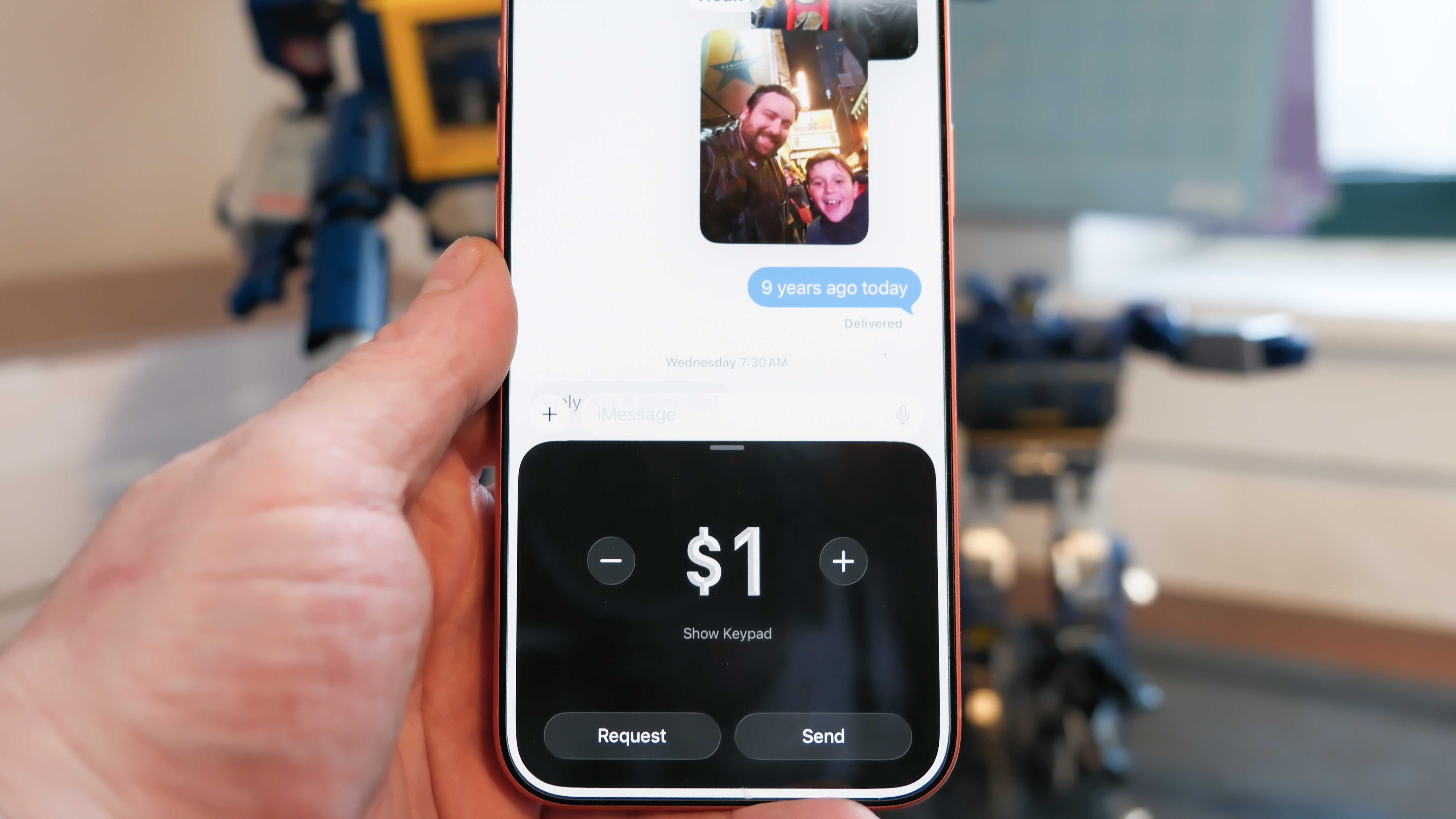 Apple iPhone 16 Pro Max in orange showing various Apple Messages features including sending check-ins, Apple Cash, and doodles