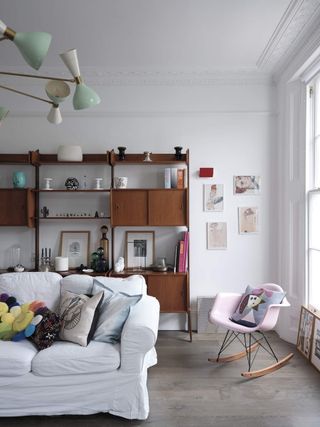 A living room with a sofa covered in slip covers