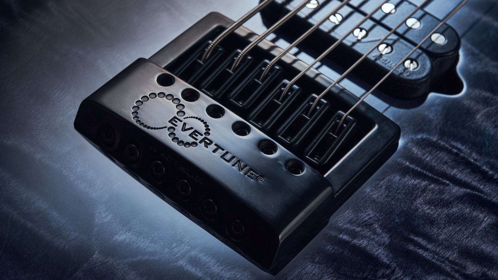 Close up of the EverTune bridge on the Jackson Signature Sleep Token IV Monarkh electric guitar