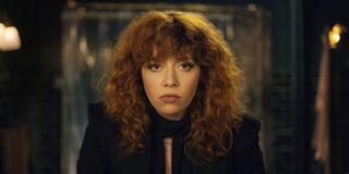 Natasha Lyonne looks into a mirror in a still from russian doll