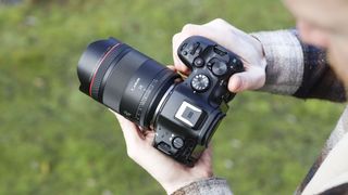 Canon RF 14mm F1.4L VCM lens in photographer Tim Coleman's hands, attached to an EOS R5 mark II