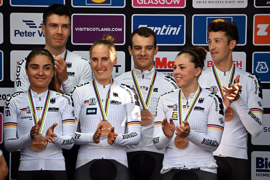 Riders from Germany celebrate with their bronze medals and cow mascots after the Team Time Trial Mixed Relay road race during the UCI Cycling World Championships in Glasgow Scotland on August 8 2023 Switzerland won gold France won silver and Germany bronze Photo by Oli SCARFF AFP Photo by OLI SCARFFAFP via Getty Images