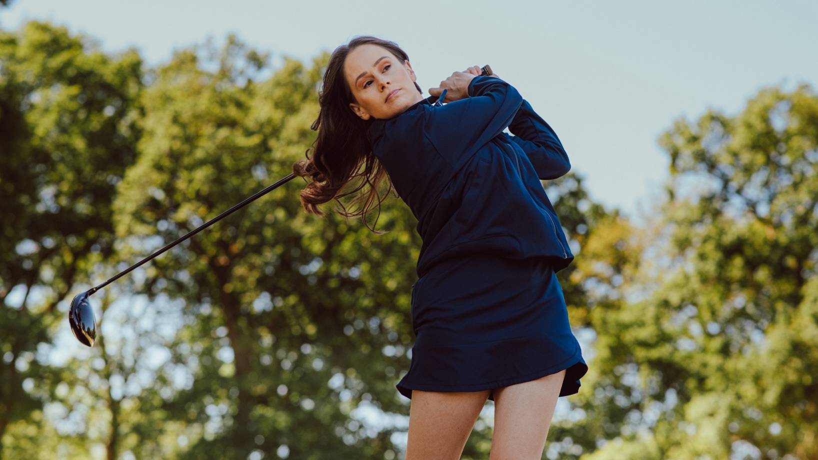 Female golfer hits a drive