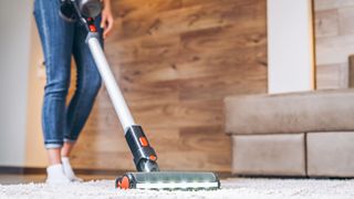 person vacuuming carpet