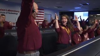 NASA entry, descent and landing systems engineers Brooke Harper (right) and Gene Bonfiglio (left) celebrate NASA's successful InSight landing on Mars with a touchdown dance in the mission control center of the Jet Propulsion Laboratory on Nov. 26, 2018 in Pasadena, California.