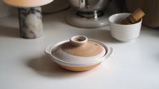 a japanese donabe with decorative glazes in a neutral kitchen