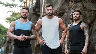 Bobby Hanton, Chris Hemsworth and Luke Zocchi standing in front of a cliff wall