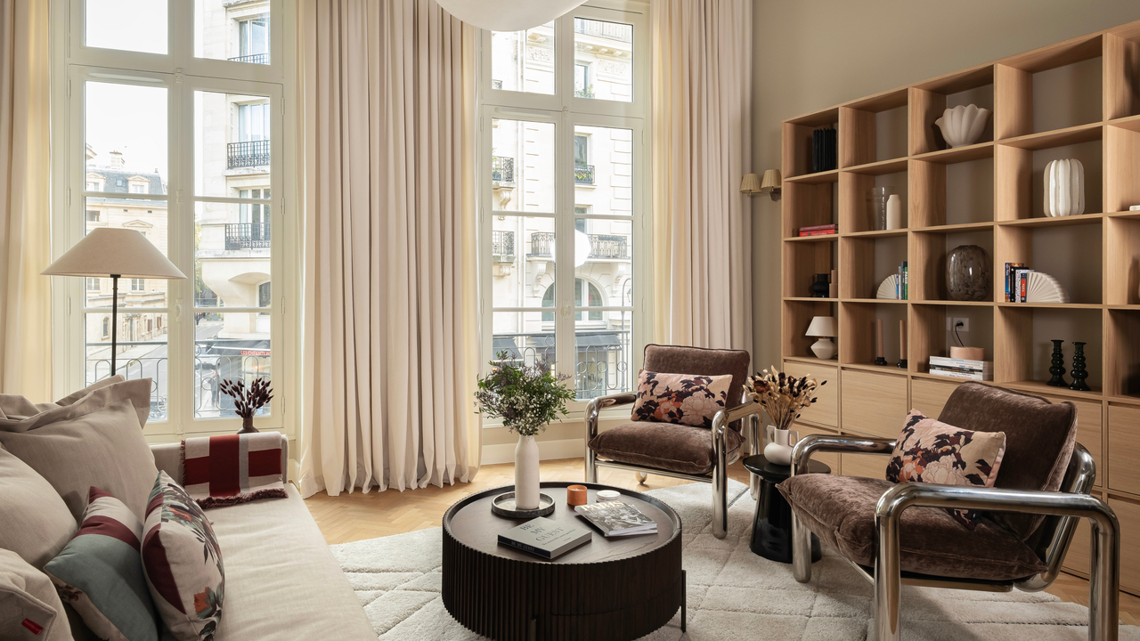 Neutral modern apartment with accent armchairs, couch and style coffee table