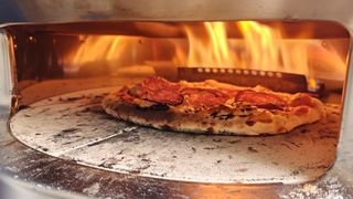 Closeup of cheese and pepperoni pizza cooking in the Solo Stove Pi Prime