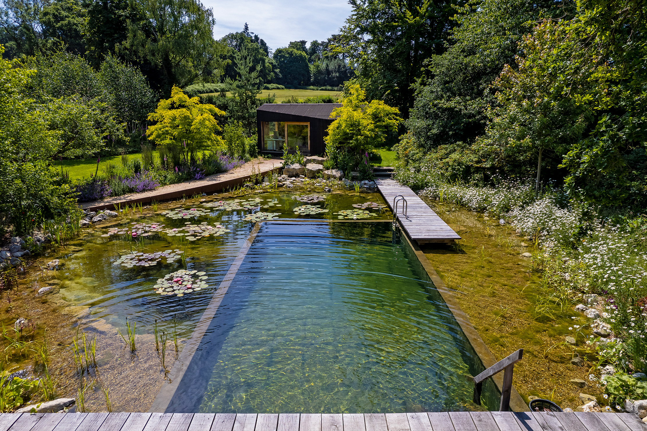 A natural swimming pool, such as this by Water Artisans, connects your home to nature.