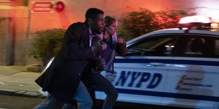 21 Bridges Chadwick Boseman and Sienna Miller run past a cop car