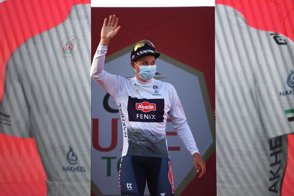 MADINAT ZAYED UNITED ARAB EMIRATES FEBRUARY 20 Jasper Philipsen of Belgium and Team AlpecinFenix celebrates at podium as White Best Young Rider Jersey winner after the 4th UAE Tour 2022 Stage 1 a 184km stage from Madinat Zayed to Madinat Zayed UAETour WorldTour on February 20 2022 in Madinat Zayed United Arab Emirates Photo by Tim de WaeleGetty Images