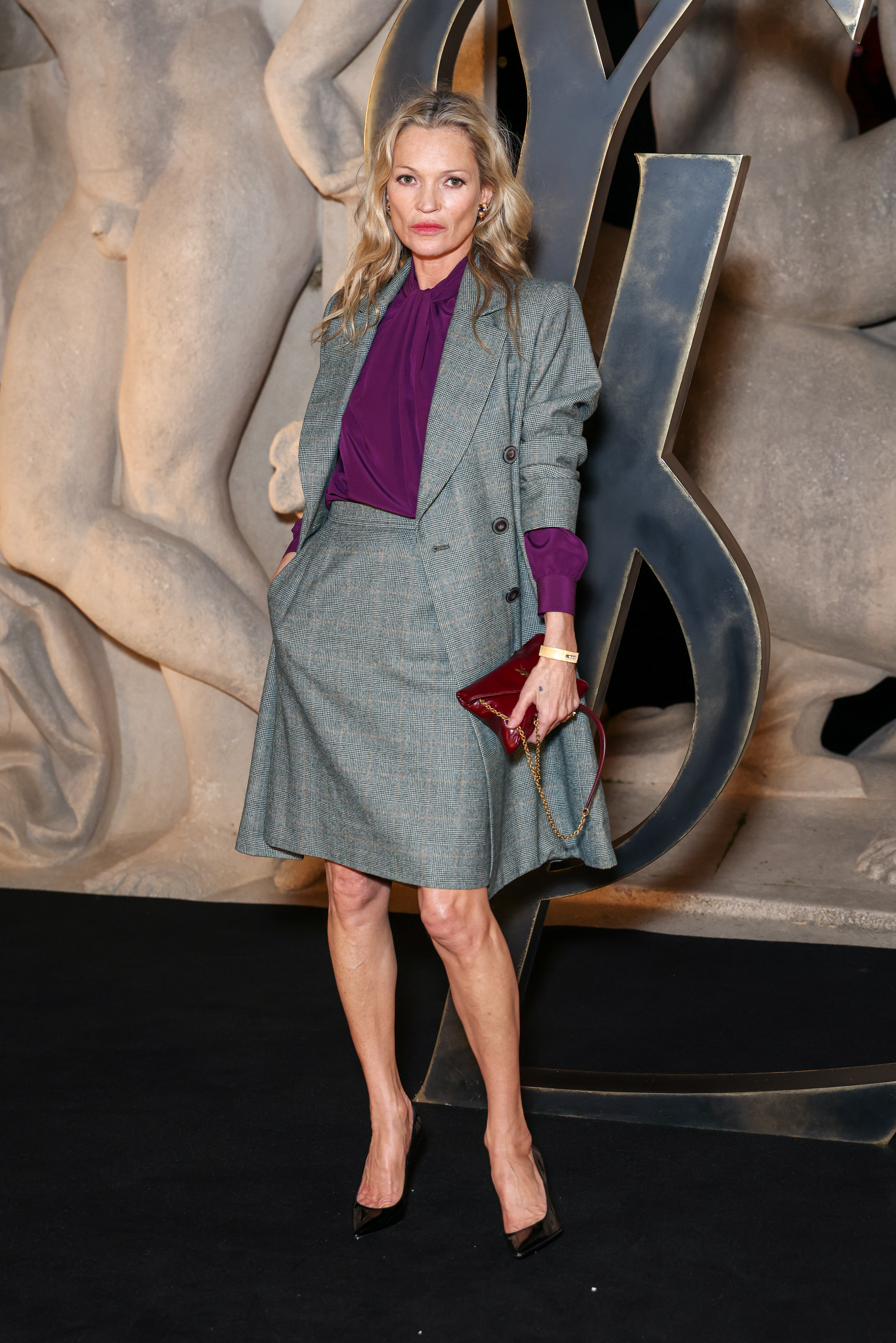 Kate Moss attended a Saint Laurent Paris Fashion Week show in a business-wear skirt set
