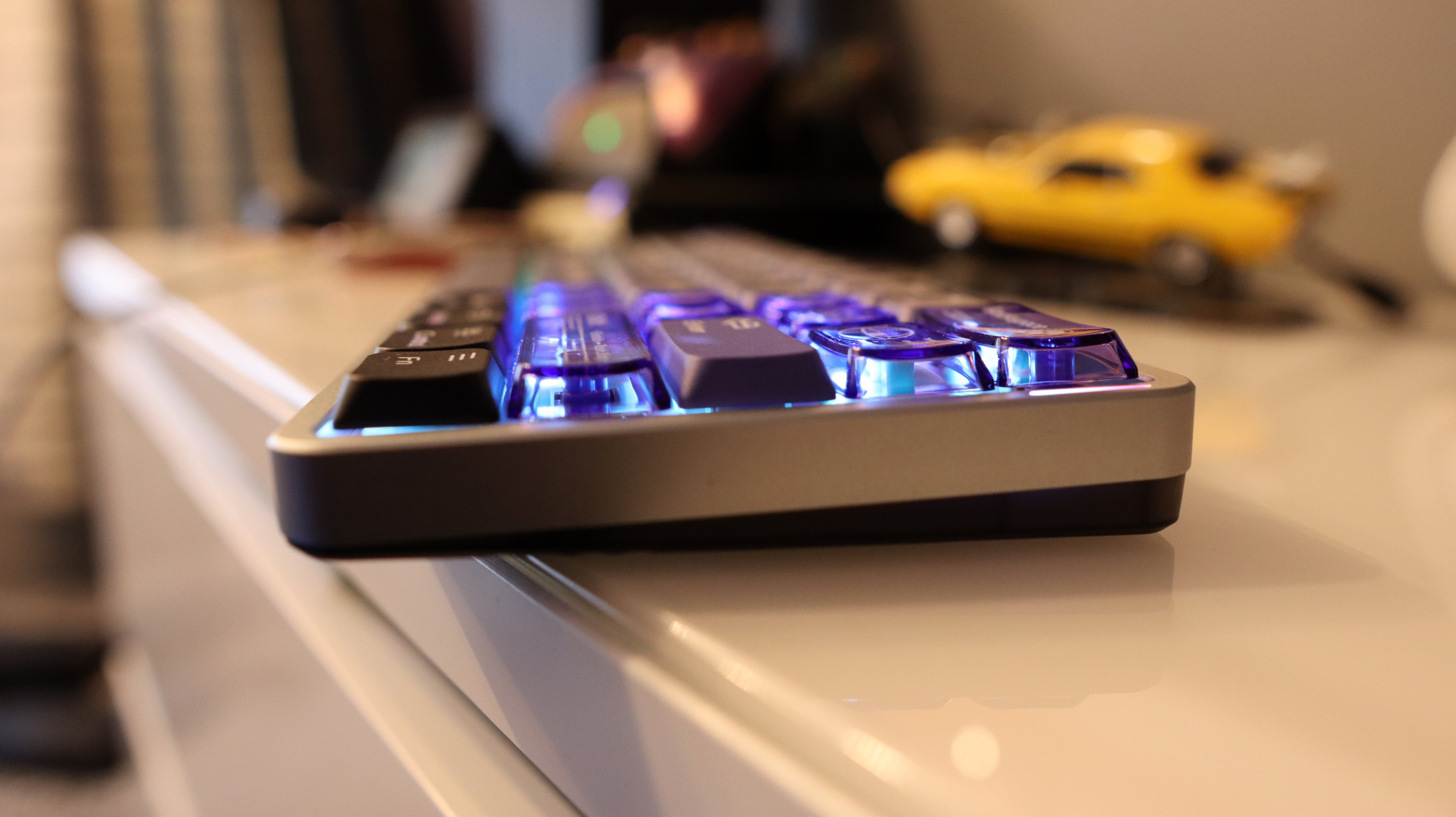 NuPhy Air60 HE gaming keyboard on a desk with RGB enabled.