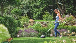 Gtech SLM50 Mini Mower being used on lawn