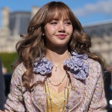 Lisa from Blackpink wore a knitted sweatsuit from Guest in Residence in the airport