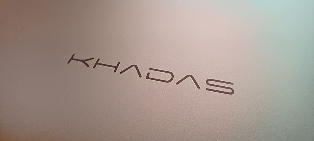 A silver Khadas Mind mini PC sitting on a wooden desk