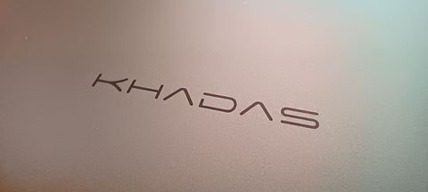 A silver Khadas Mind mini PC sitting on a wooden desk
