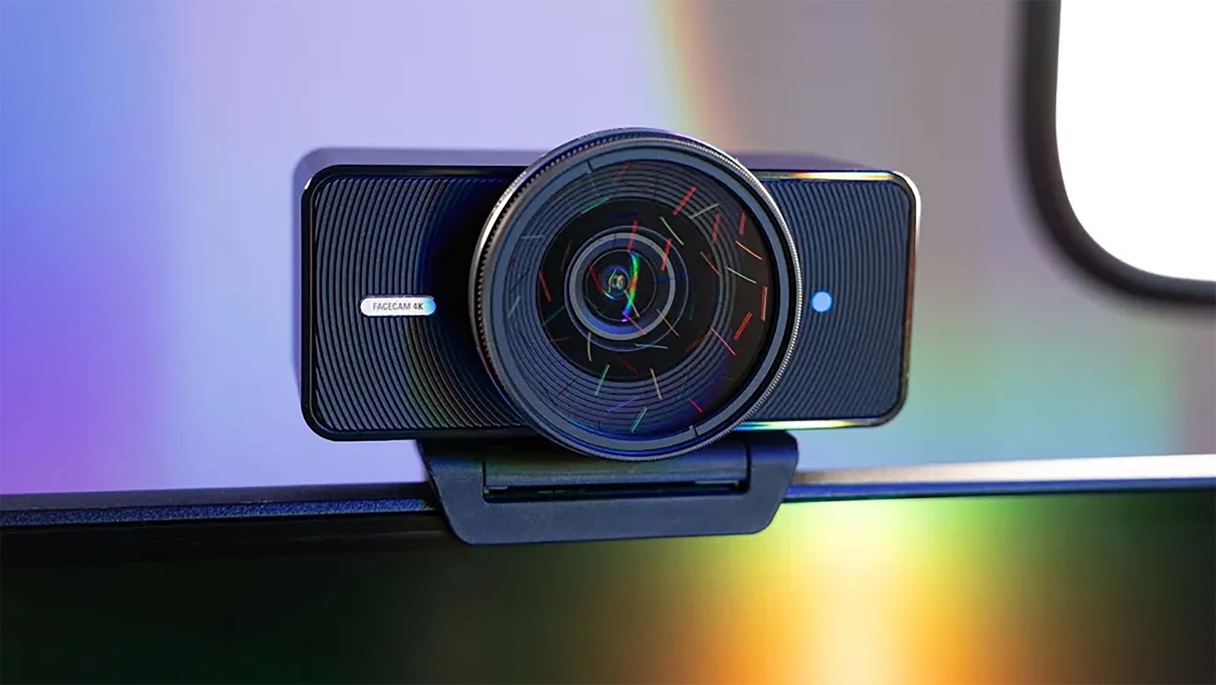 Elgato Facecam 4K on top of a monitor. An orange to green prism of color lights up the display.